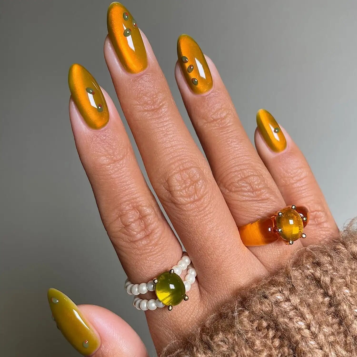 Amber and olive velvet nails with gold sparkle inspired by a dirty martini cocktail.