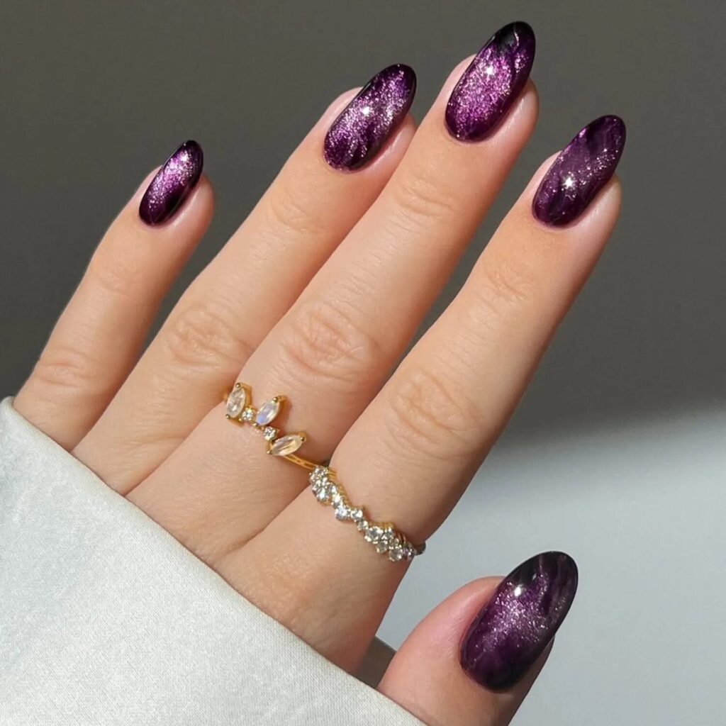 Long plum cat-eye nails with magnetic shimmer and reflective light play