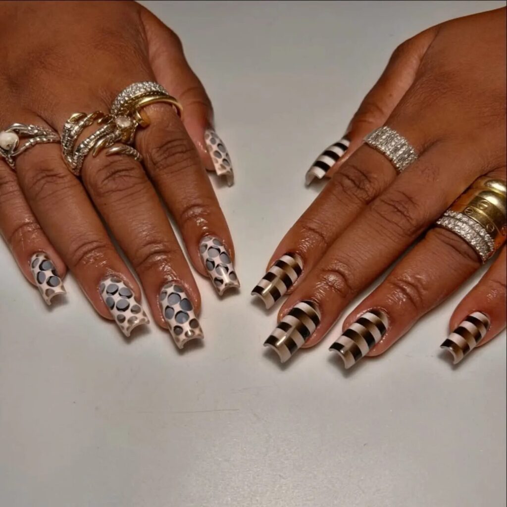 Minimalist manicure in ivory and moody gray tones with abstract pattern design