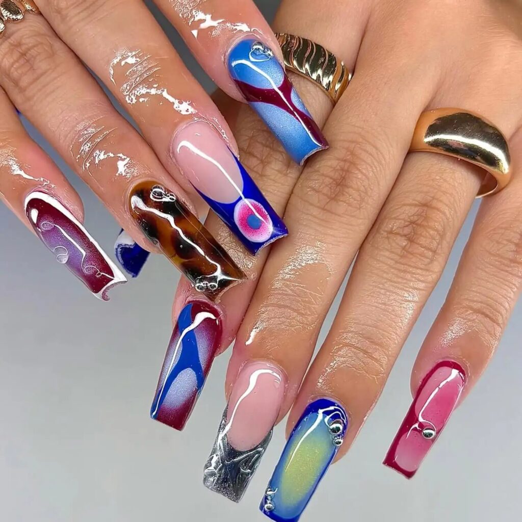 Dark blue and tortoiseshell nails with metallic sheen inspired by Scorpio’s water element