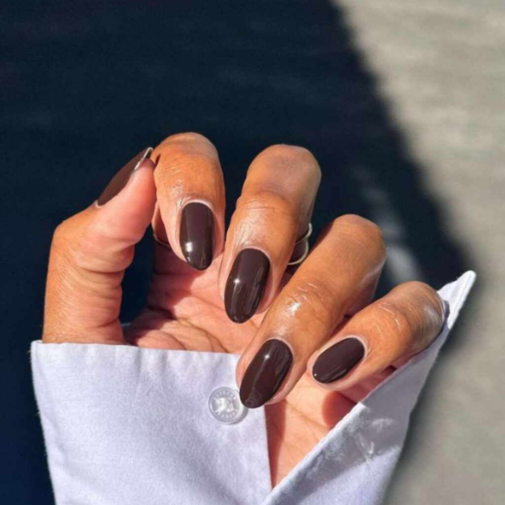 Modern French manicure featuring espresso-brown tips with a nude base for a chic, minimalist contrast.