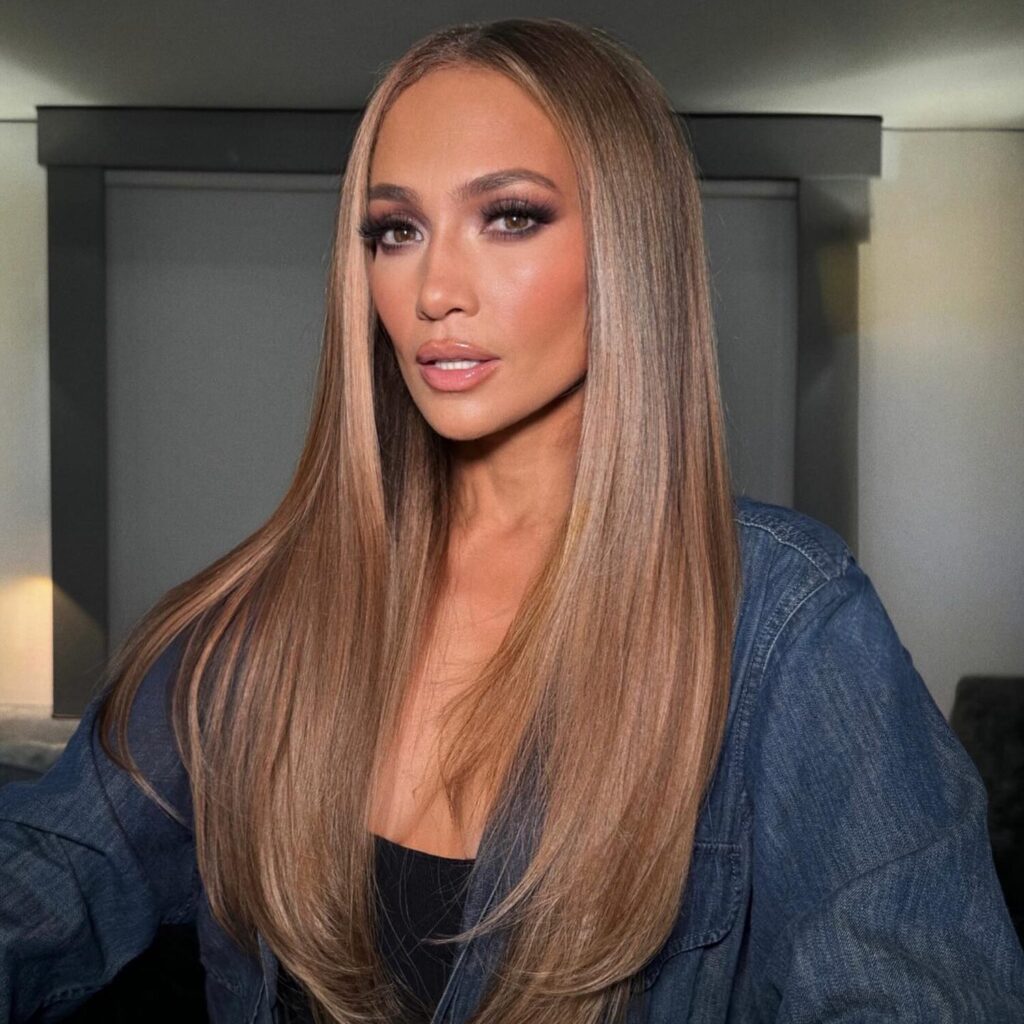 Creamy honey-blonde tones styled in voluminous curls