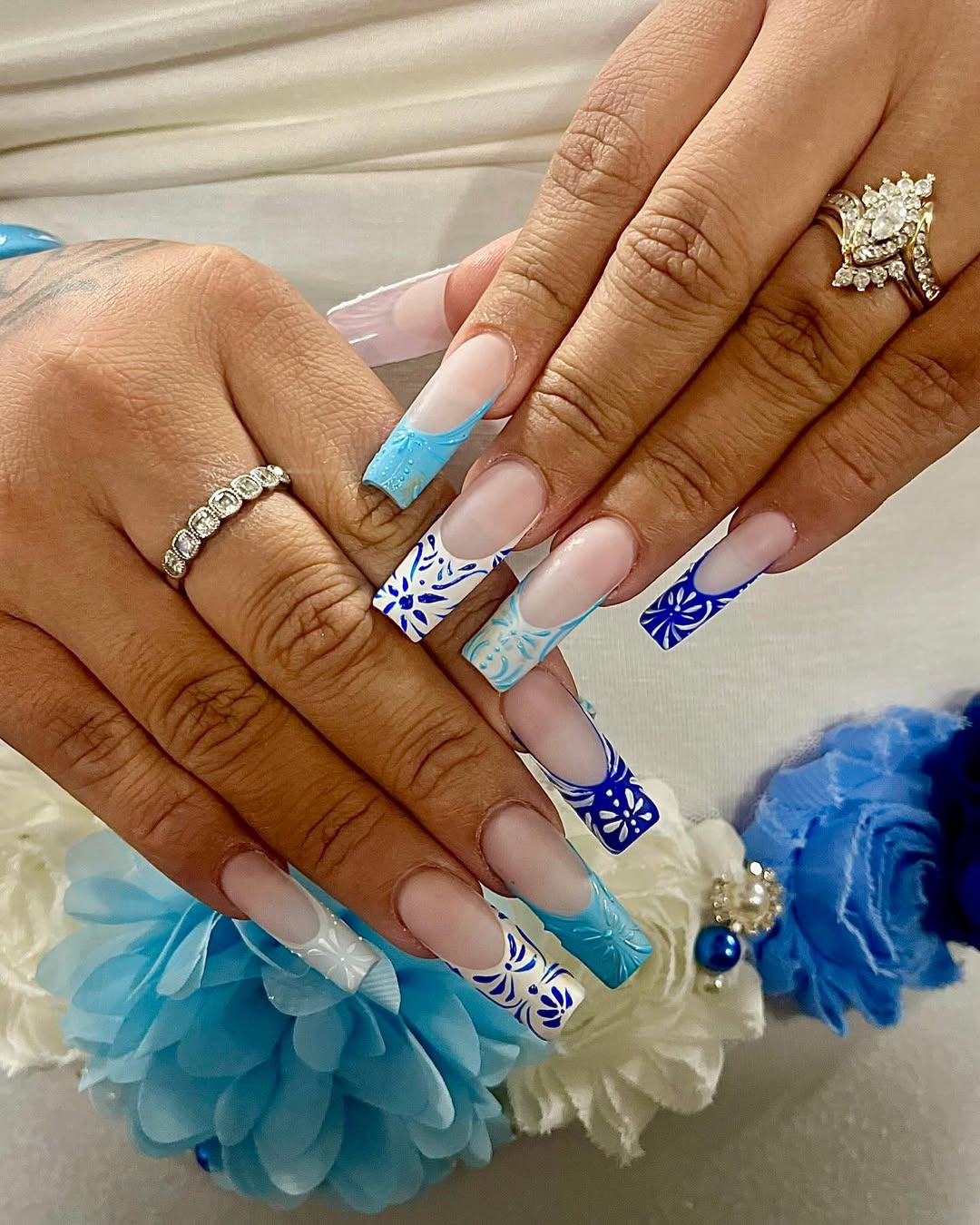 Icy blue and white nails with delicate floral designs