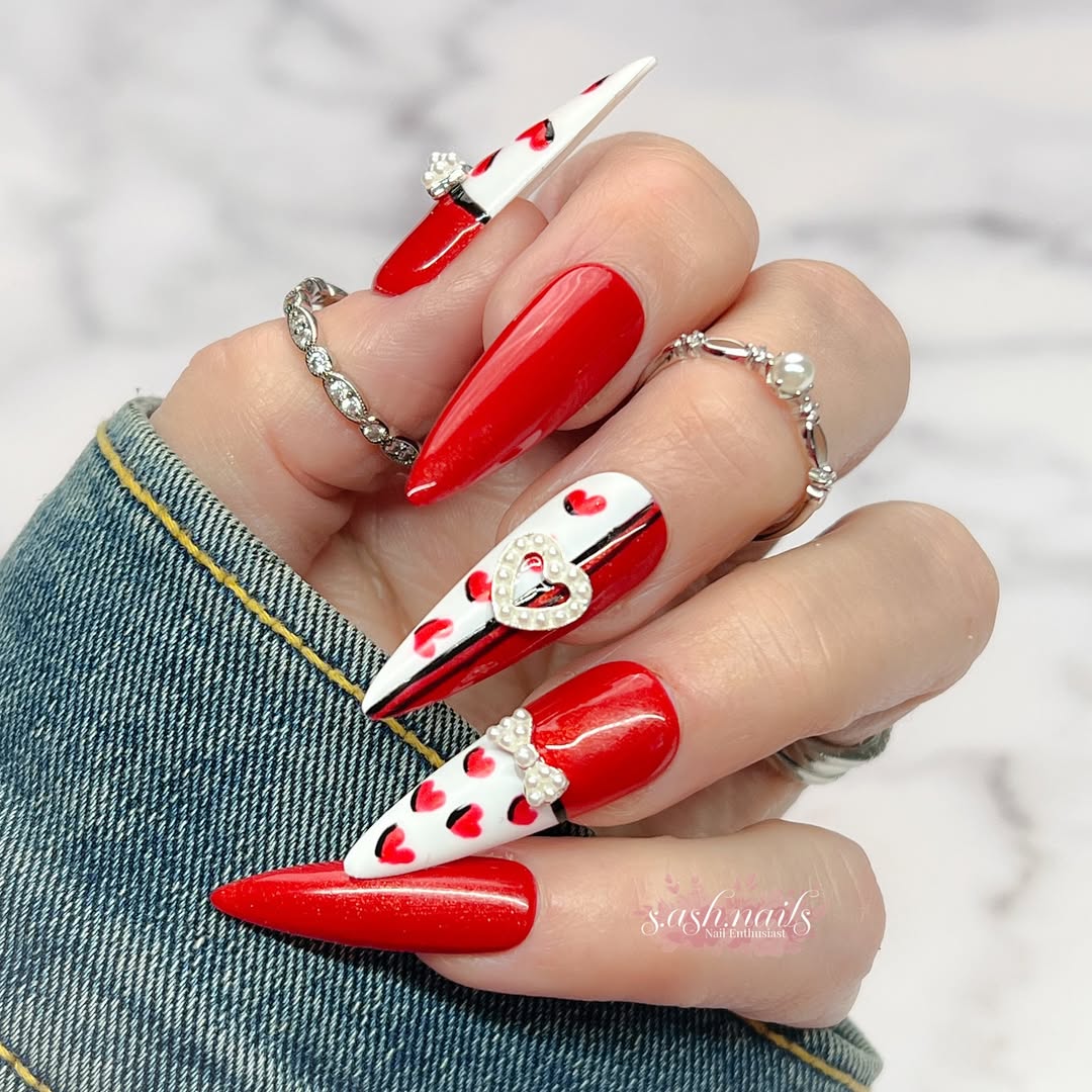 Bold red nails with clean shapes and subtle heart accents