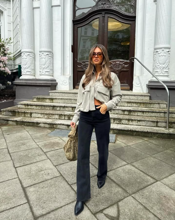 A woman wearing neutral-toned, sleek clothing for a confident city look.