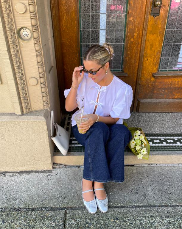 A crisp white blouse and relaxed denim for a coffee stop.