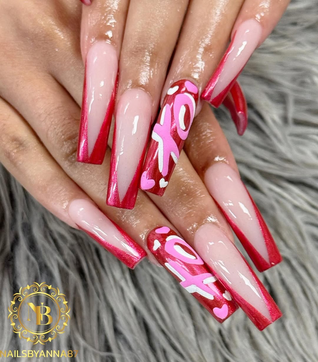 Glossy red and pink nails with hearts and statement details