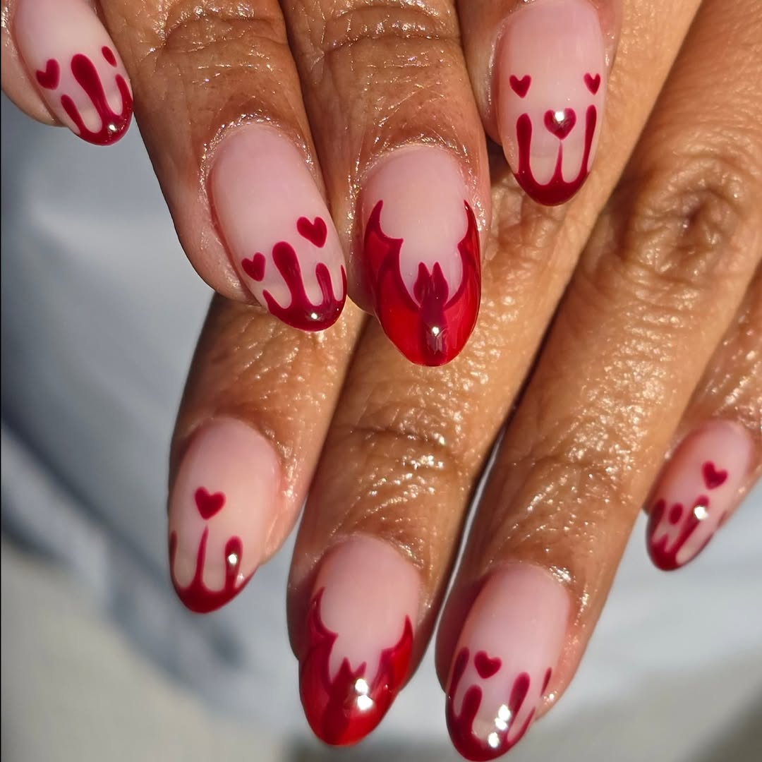 Bright pink nails with heart accents and a glossy finish