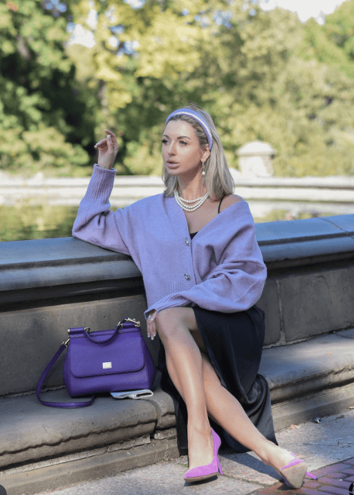 Woman in a lilac cardigan, pearls, and matching heels, embodying lavender daydream chic.
