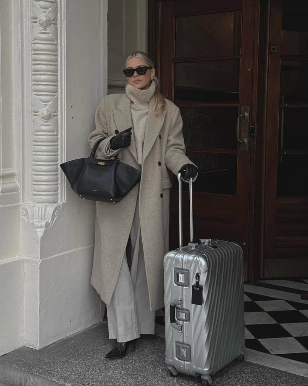 Modern minimalist airport outfit with a clean aesthetic.