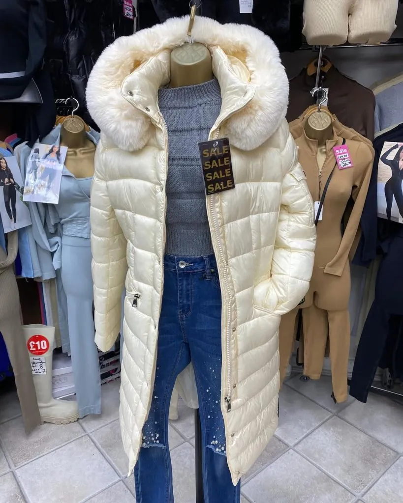 A structured hooded coat with a functional hood in a utility-inspired style.