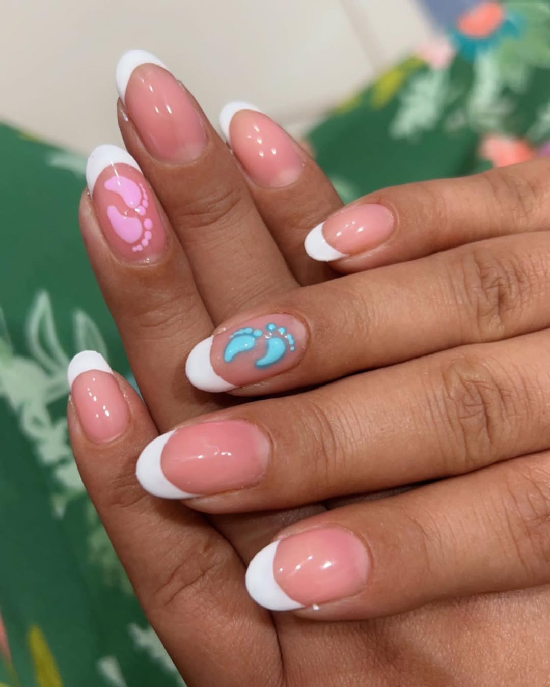 French tips with tiny blue and pink footprints on accent nails