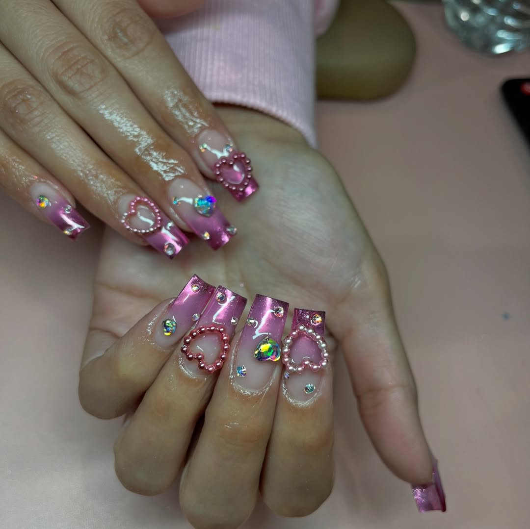 Nails with varied designs including hearts and soft pinks