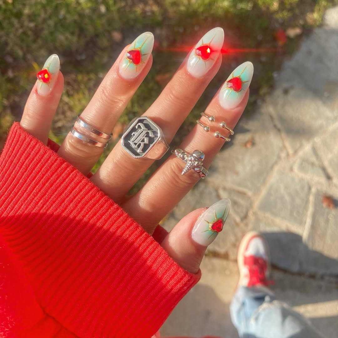 Bright nails with bold heart motifs and sparkle