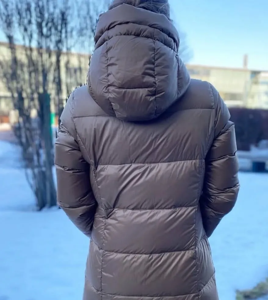 A hooded coat in a muted blush tone with plush texture, offering cozy elegance.