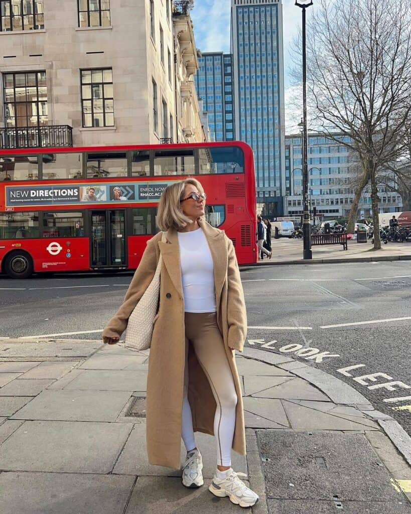 Woman in a faux fur coat paired with relaxed denim, embodying quiet luxury with plush textures.