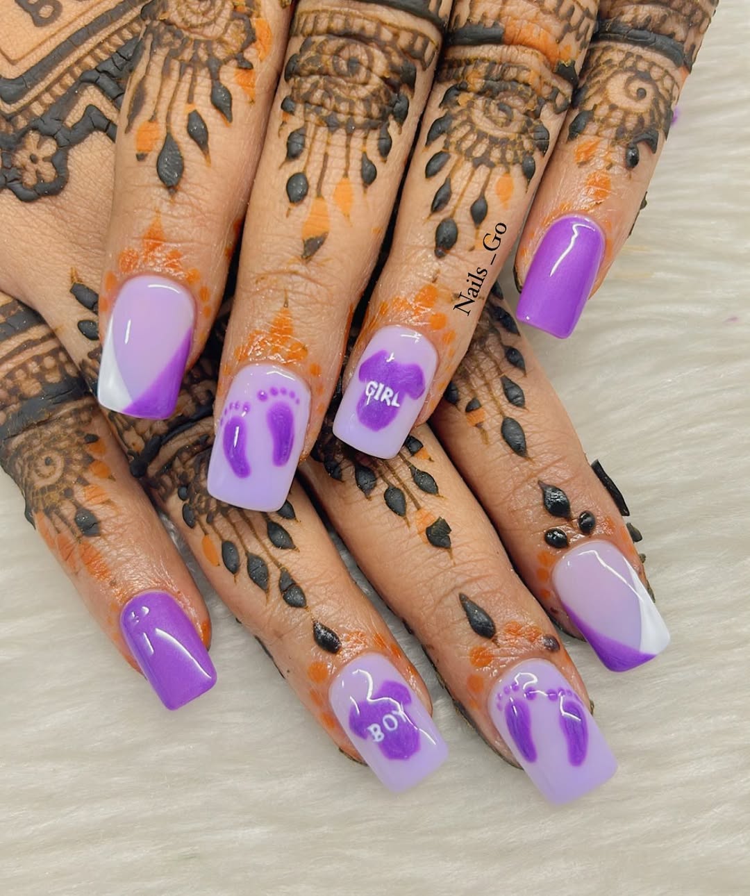 Lavender and deep purple nails with 'BOY' and 'GIRL' lettering and footprints