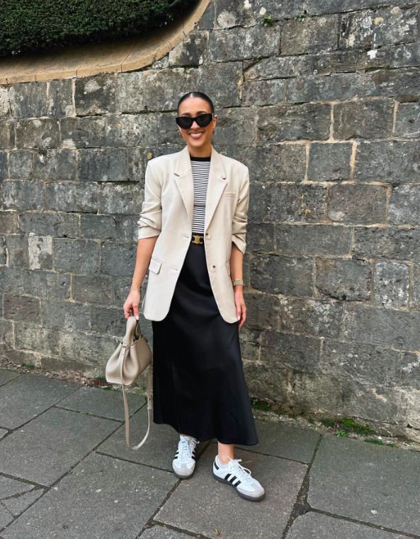 A blazer with a flowy skirt and sneakers.