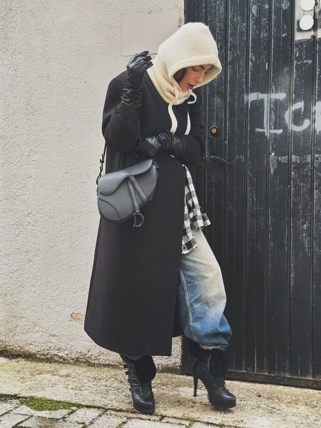 A neutral-toned hooded coat with refined tailoring and a subtle hood detail.