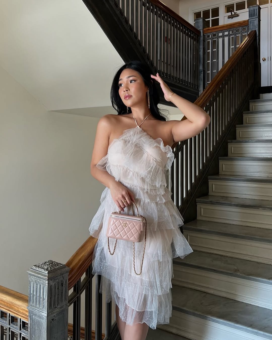 A layered tulle dress in a soft neutral tone.