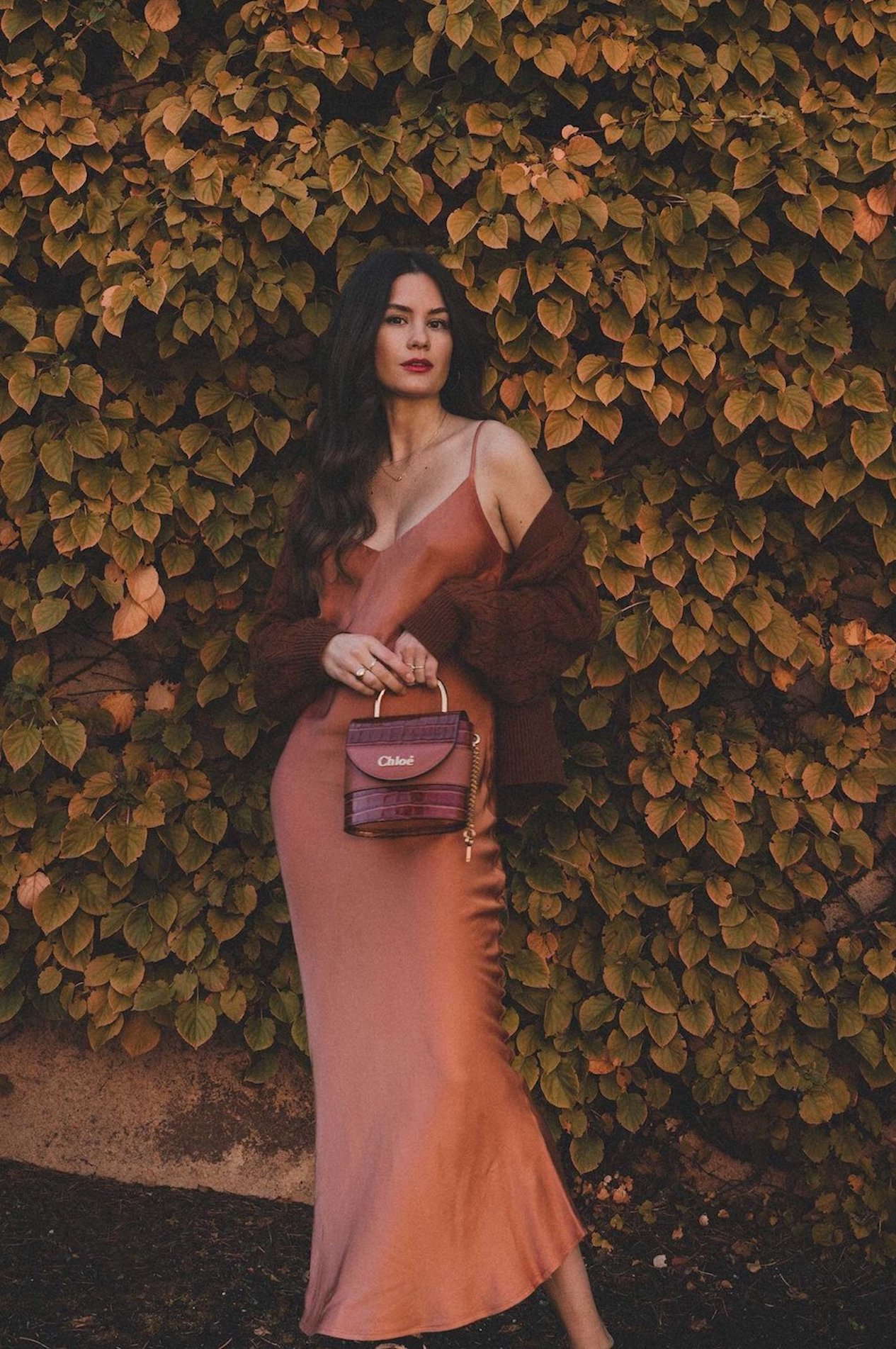 Woman wearing a maxi dress and a cardigan.