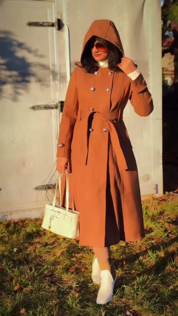 A caramel-colored hooded coat with a belted waist, offering warm sophistication.