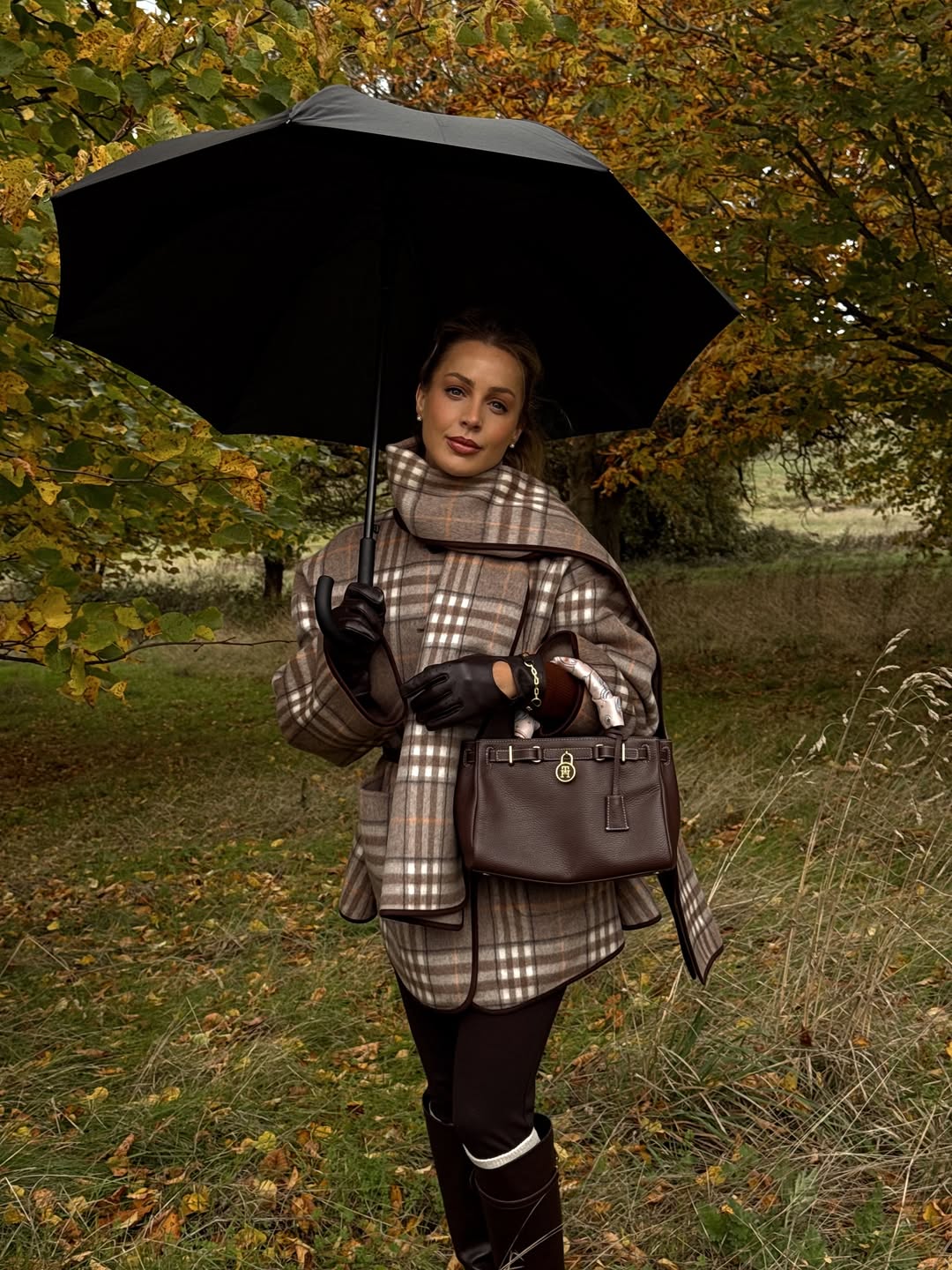 Plaid coat, scarf, riding boots, and leather gloves