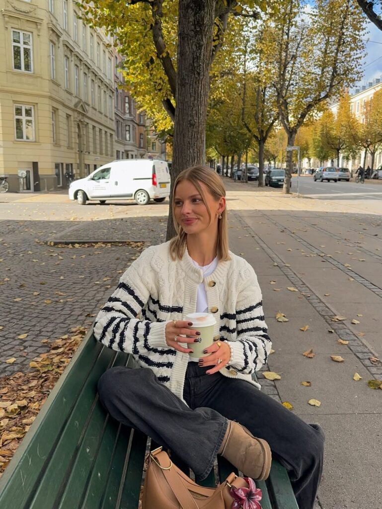 Cream and navy striped cardigan with washed black jeans and a white tee.