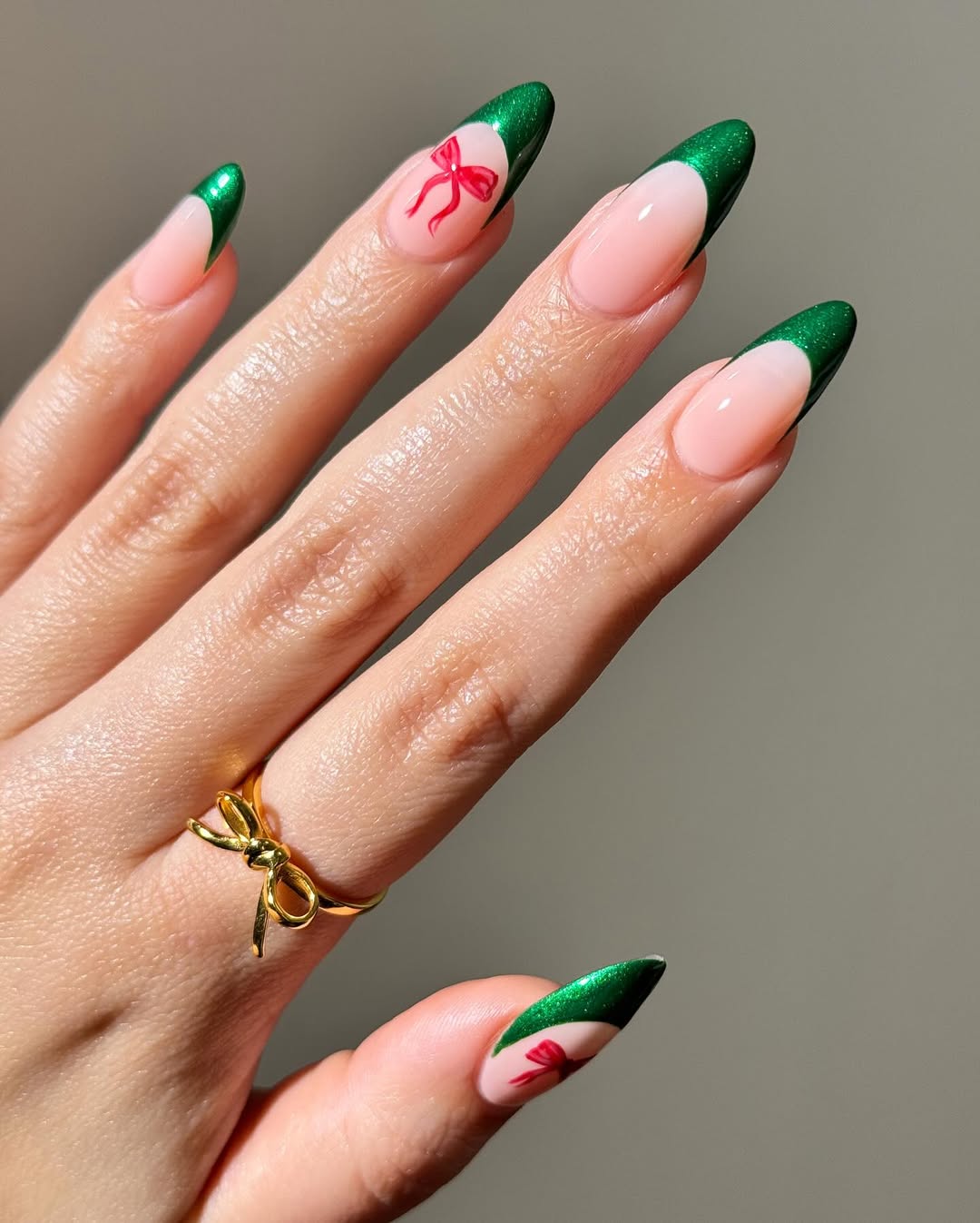 Emerald green glitter French tips with a red bow accent