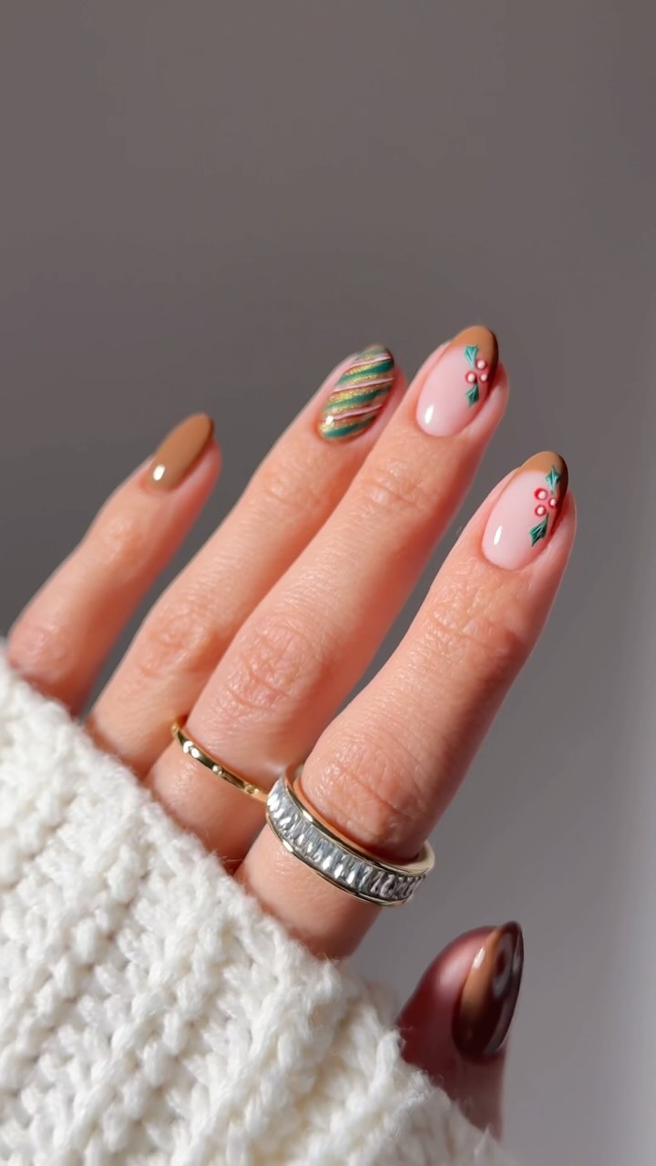 Caramel brown nails with green shimmer stripes and holly accents.