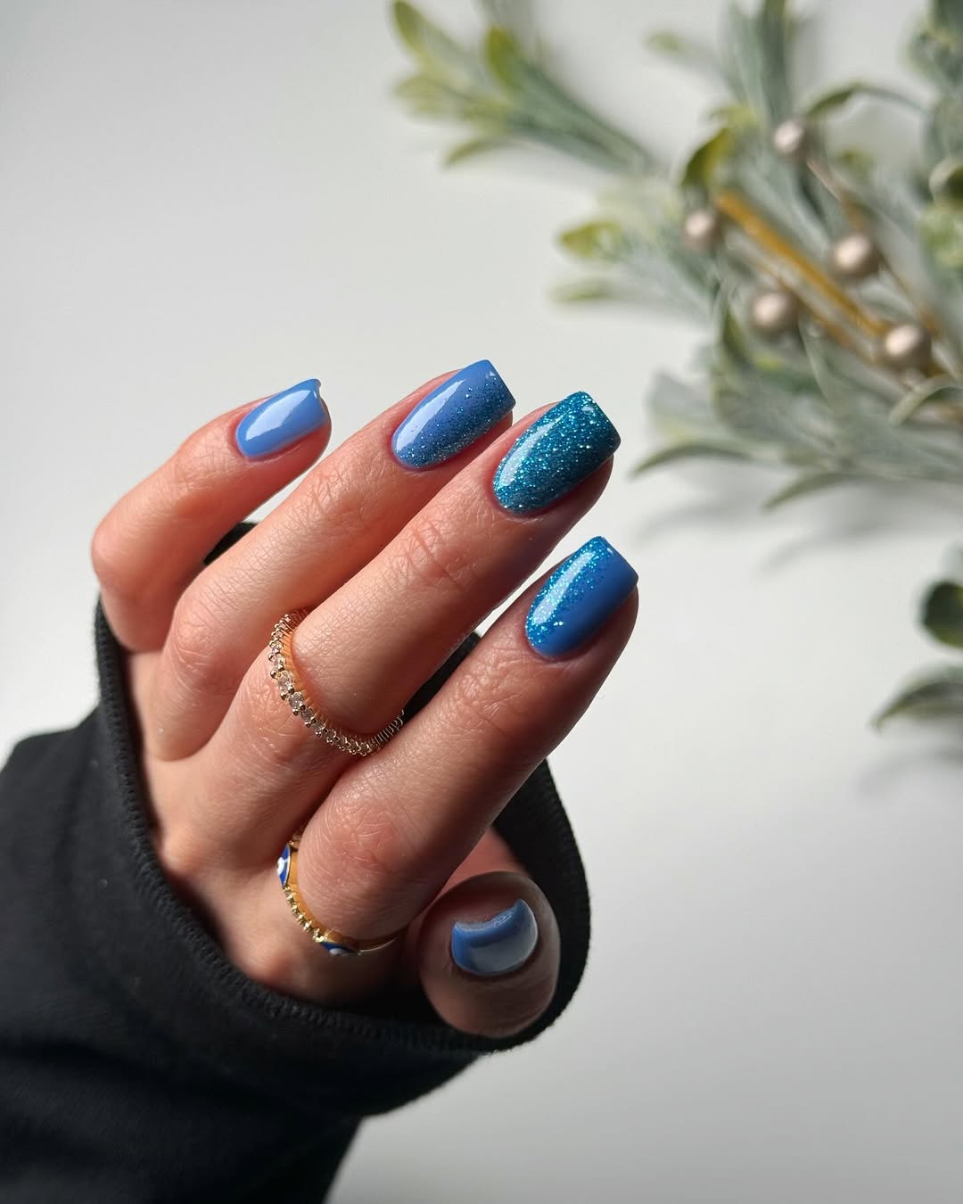 Short square nails with an icy blue glitter gradient.