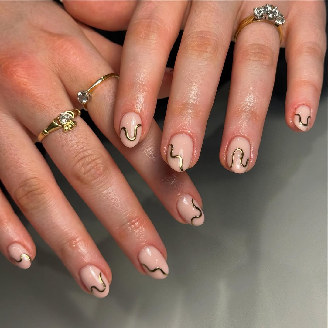 Nude nails with thin gold wave details