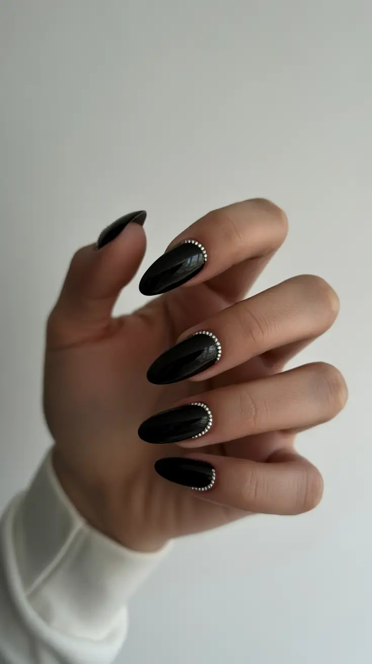 Glossy faceted black nails with bead accents