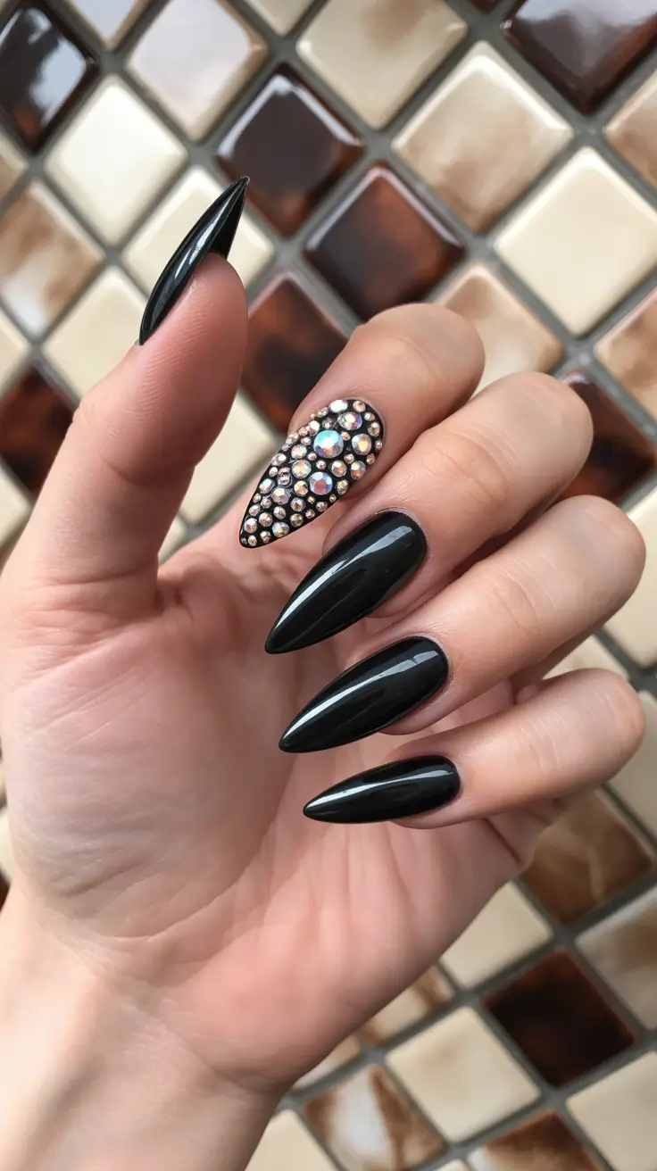 Almond black nails with crystal embellishments