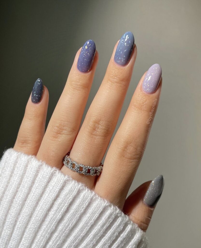 Short winter nails with a grey and purple gradient finish.