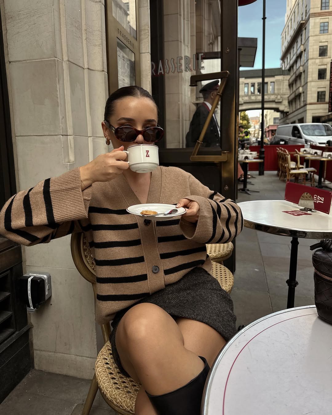Striped cardigan with a charcoal mini skirt and knee-high boots.