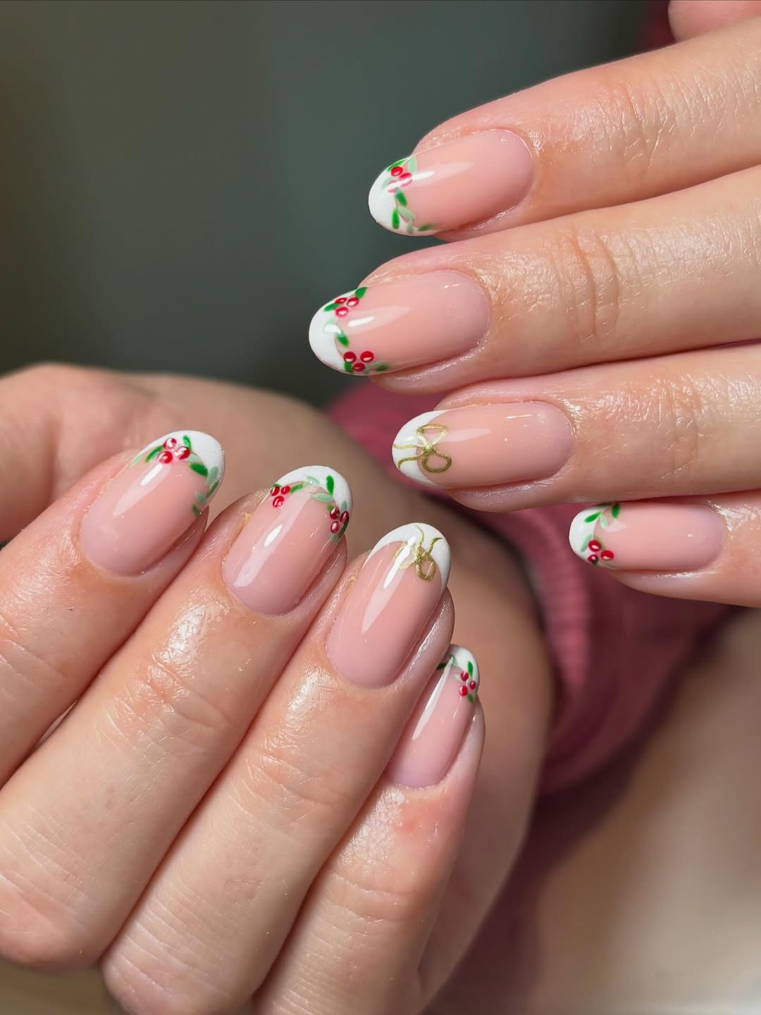Nude nails with white French tips adorned with holly and berries.