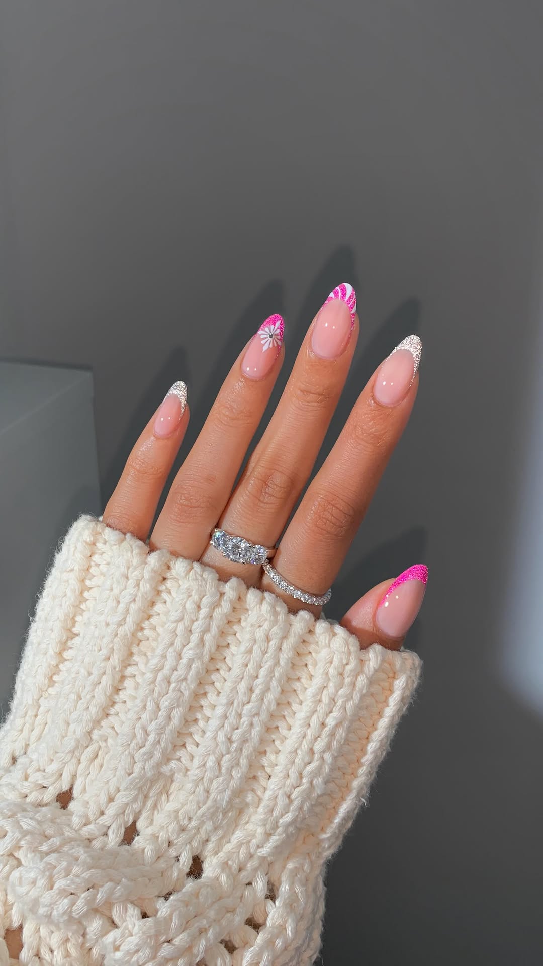 Pink glitter French tips with snowflakes and candy cane stripes