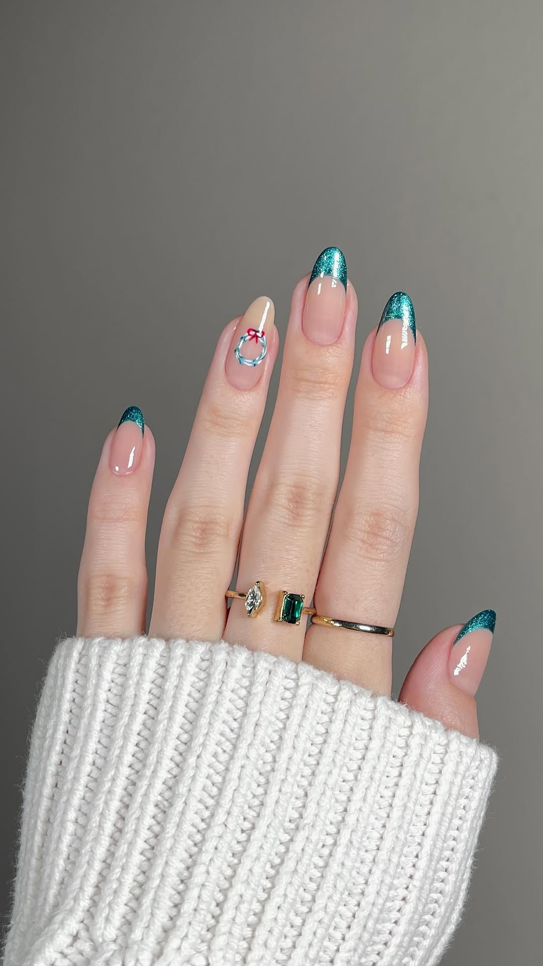 Teal glitter French tips with a small wreath accent nail