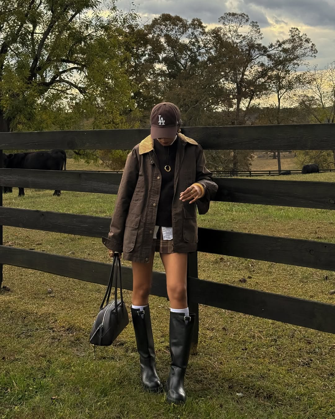 Barn coat, turtleneck, plaid mini skirt, and riding boots