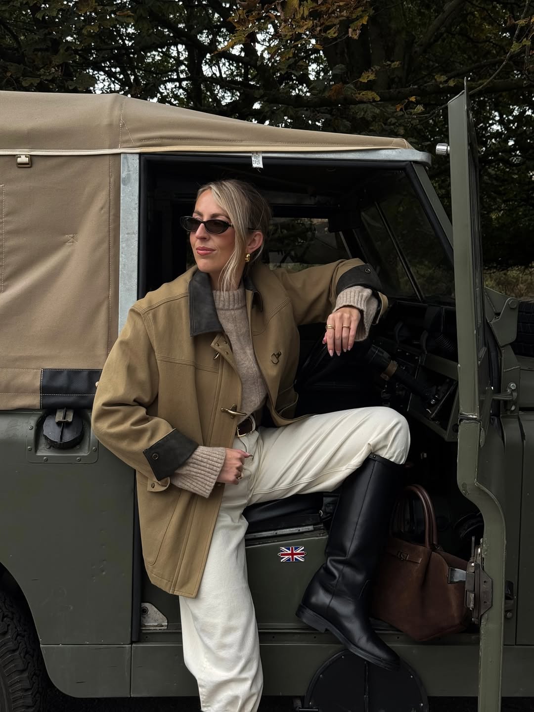 Field jacket, beige turtleneck, ivory trousers, and riding boots