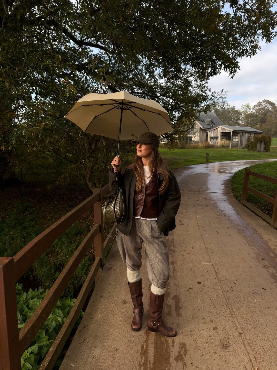 Waxed jacket, leather vest, tweed trousers, and riding boots