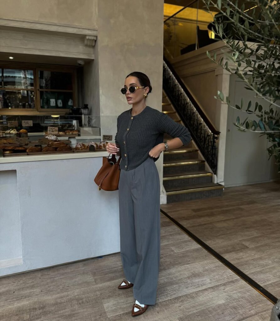Charcoal ribbed cardigan with grey wide-leg trousers and loafers.