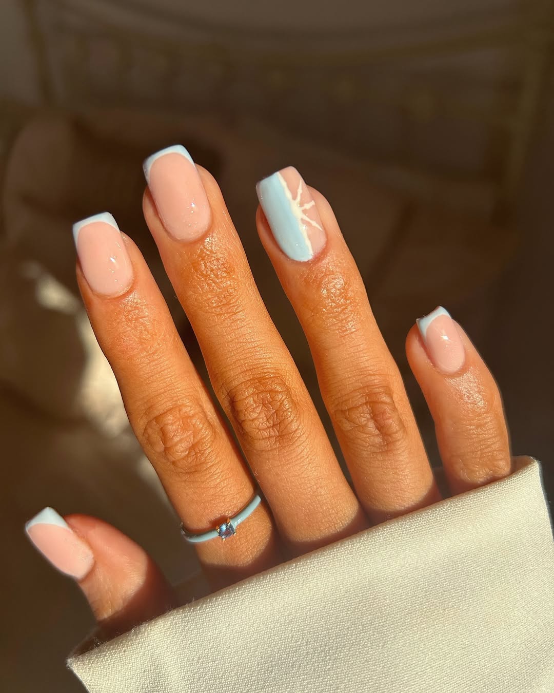 Baby blue French tips with block edges and abstract snowflake