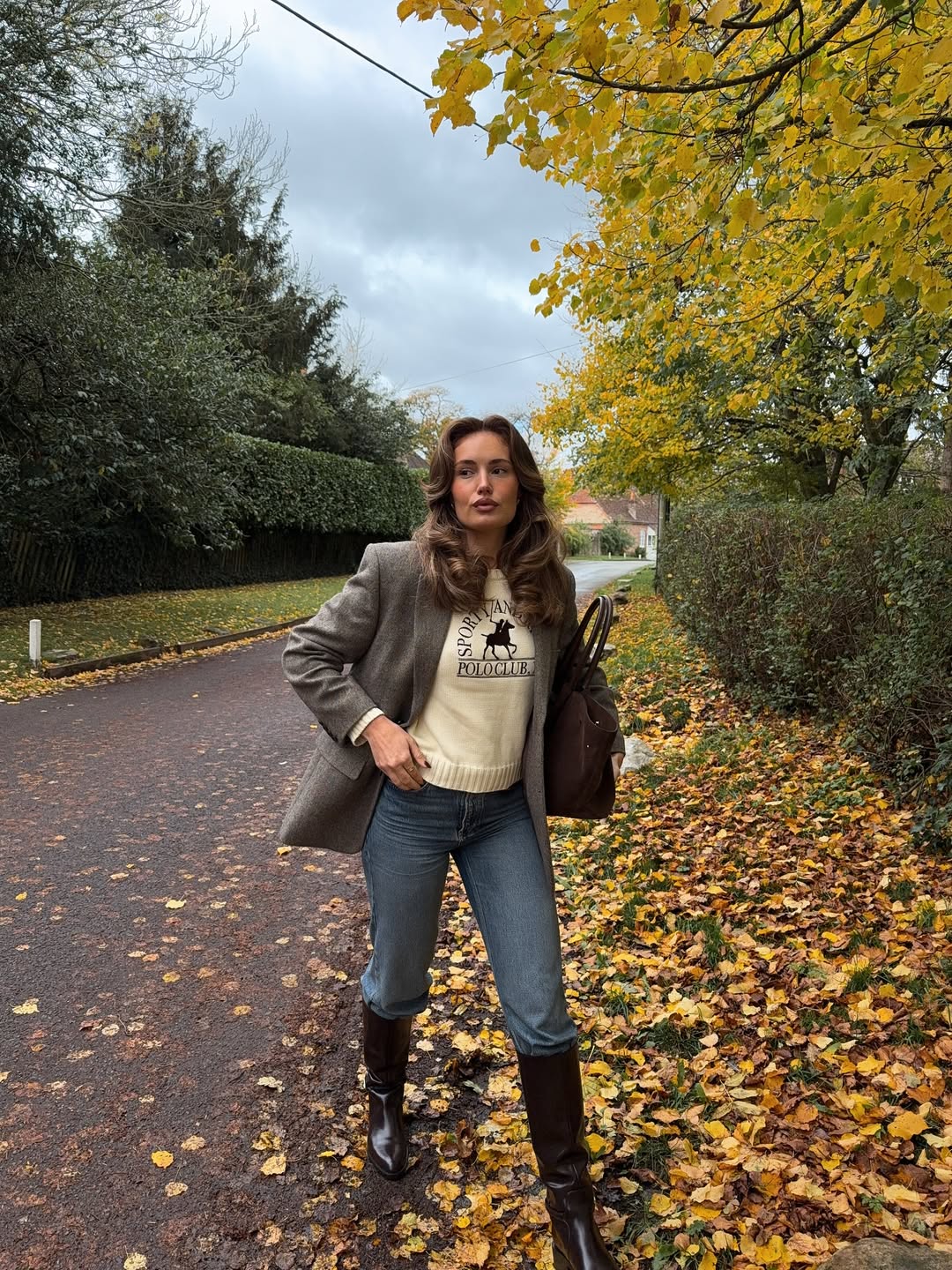 Tweed blazer, cream polo sweater, denim, and riding boots