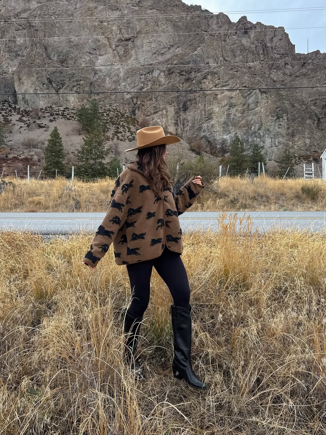 Cowboy hat, shearling jacket, and riding leggings