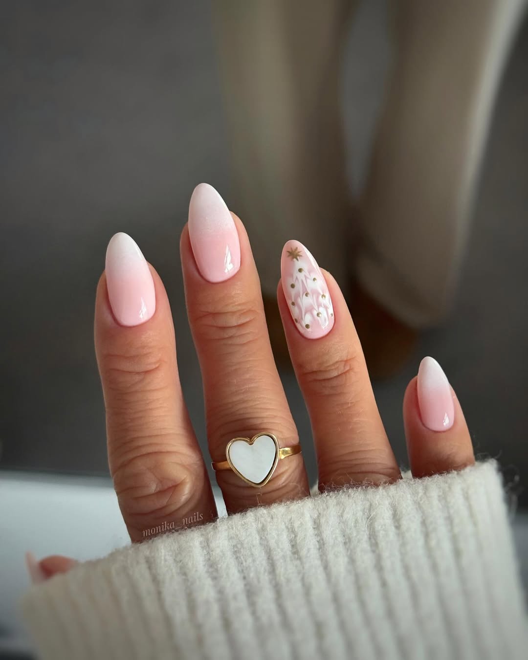Pink to white ombre nails with a single accent nail featuring a minimalist gold-trimmed Christmas tree.