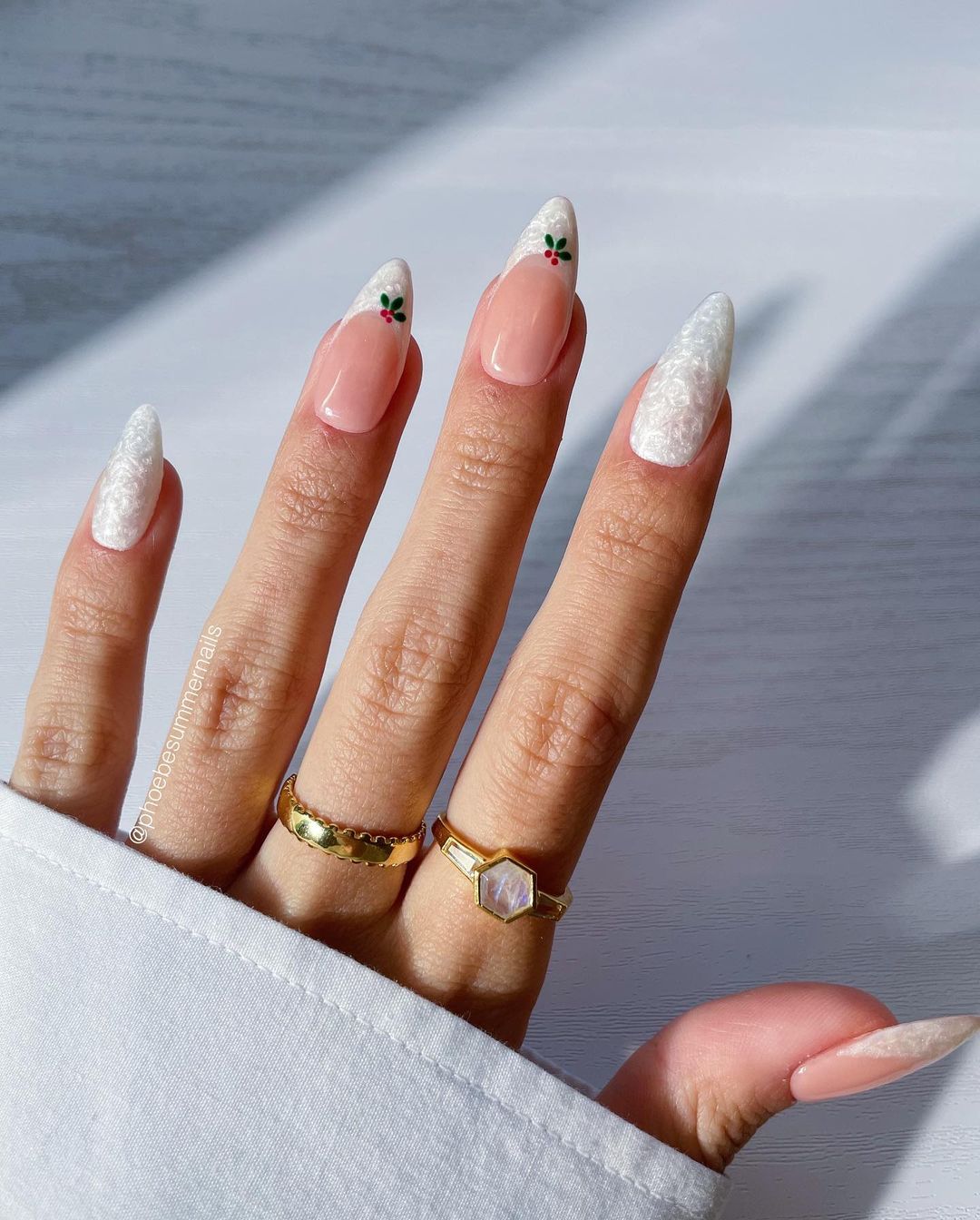 White textured French tips with delicate holly accents on a nude base.