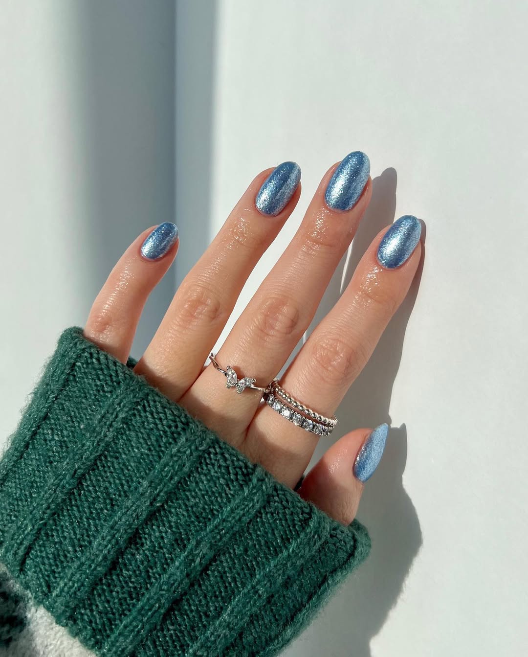 Metallic icy blue nails with a smooth, high-shimmer finish.