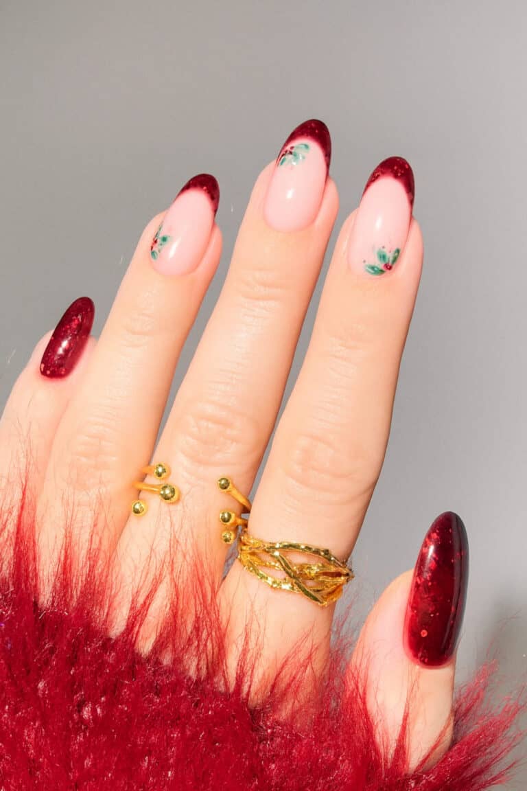 Sheer blush base with deep wine-colored tips and small floral accents.